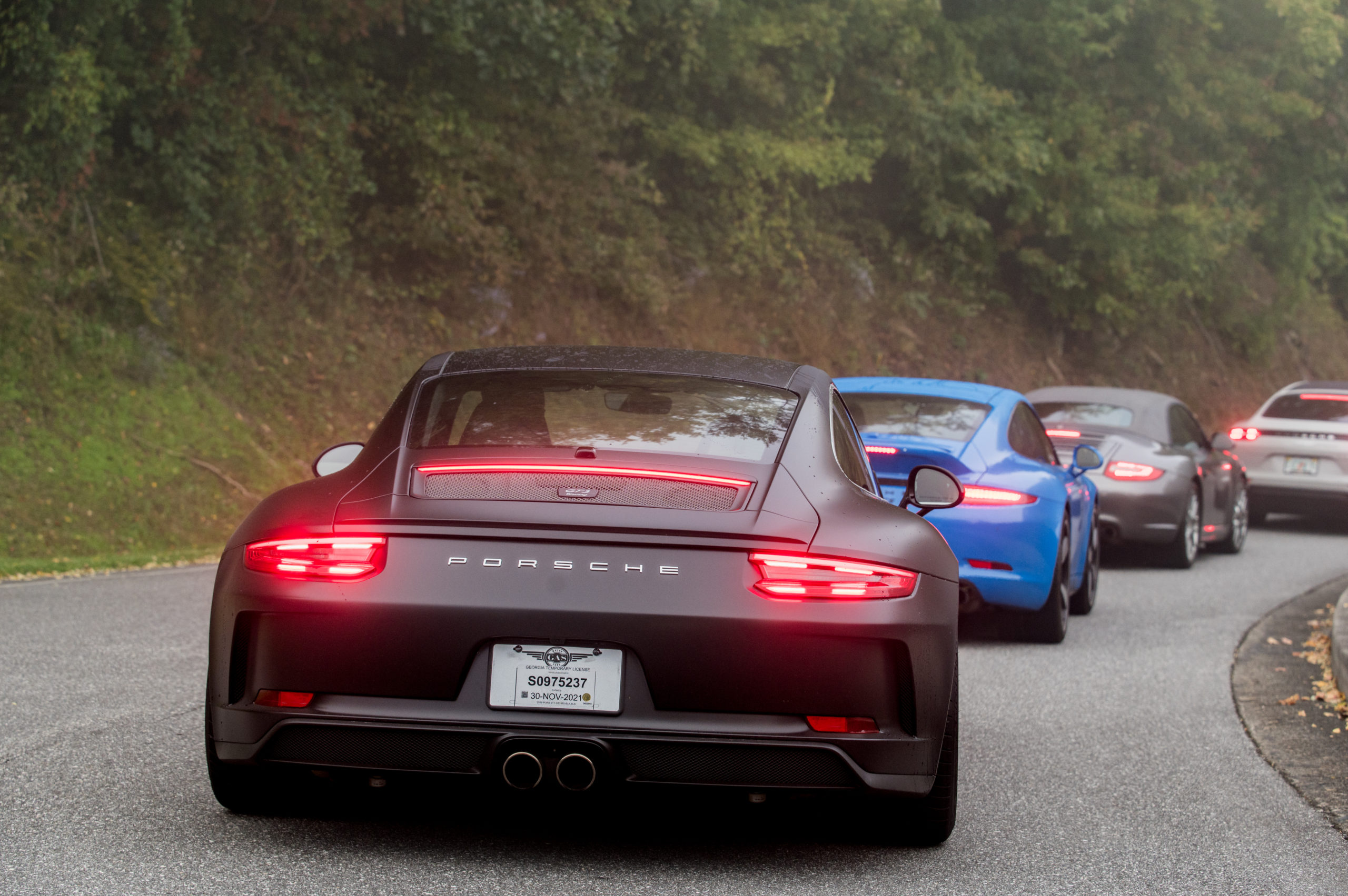 Porsche 911 GT3 behind a GTS coupe and cabriolet.